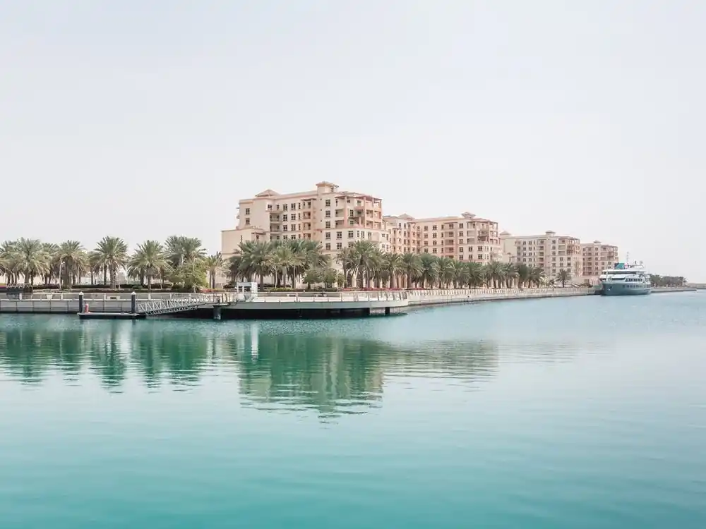 Last Chance Buildings With Palm Trees And Water
